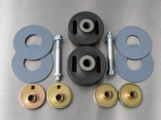 One-axle suspension kit with two bushings, four plastic washers, two bolts and four alignment collars, overhead view